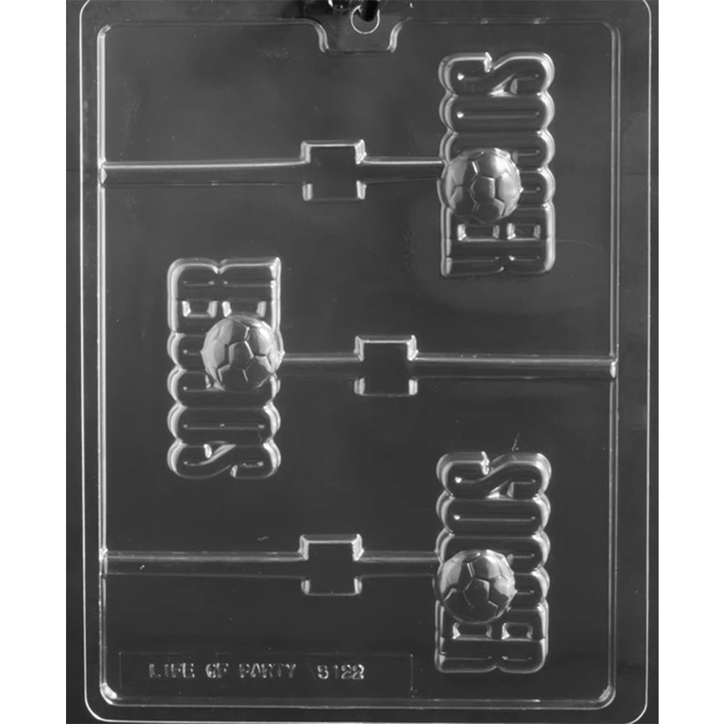 Clear plastic chocolate lollipop mold with three “Soccer” word cavities featuring a raised soccer ball detail and stick channels, shown on a dark background.