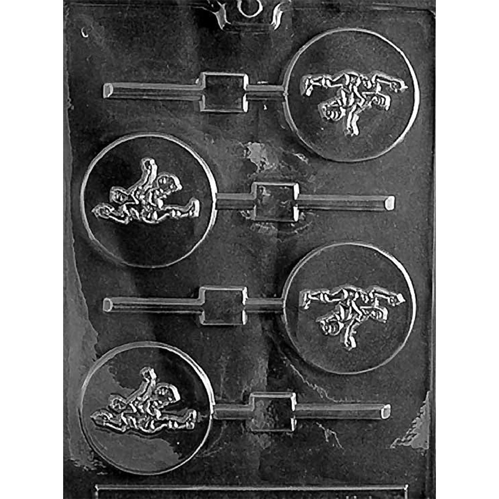 Clear plastic chocolate lollipop mold with four round cavities, each showing a raised soccer player kicking a ball, with stick channels on a dark background.