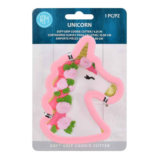 Unicorn-shaped soft-grip cookie cutter in pink, attached to retail packaging with product details.