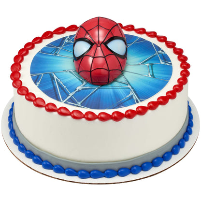 Spider-Man topper on a round cake with a printed web design and red and blue borders.