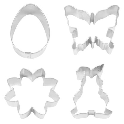 Four stainless steel cookie cutters in the shapes of a bunny, butterfly, daisy, and egg, displayed on a white surface.