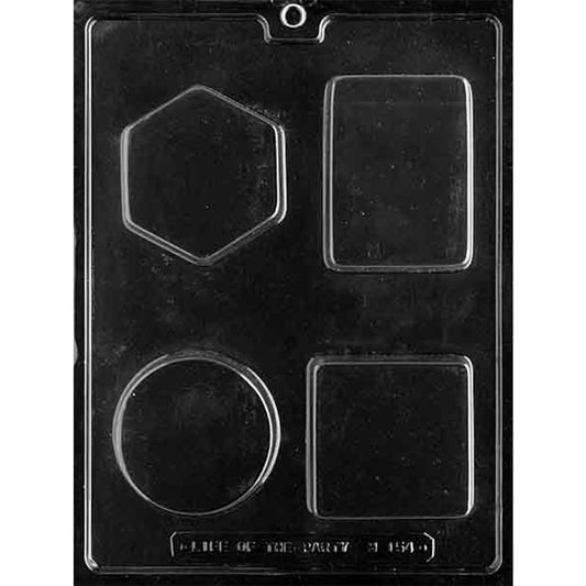 Clear plastic chocolate mold photographed on a dark background with four large cavities shaped like a hexagon, a tall rectangle, a circle, and a square.