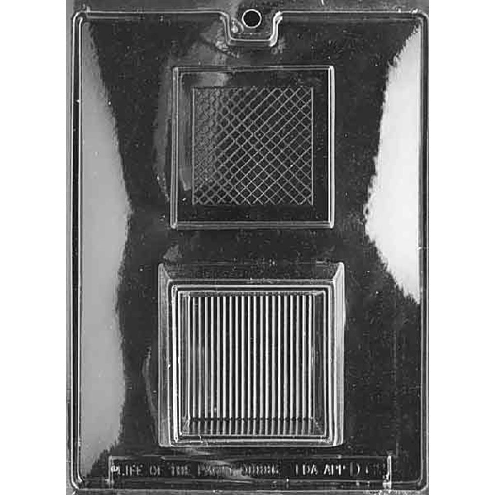 Clear plastic two-piece chocolate pour box mold with two large square cavities, one designed as a textured lid panel and the other as a deeper base, shown on a dark background.