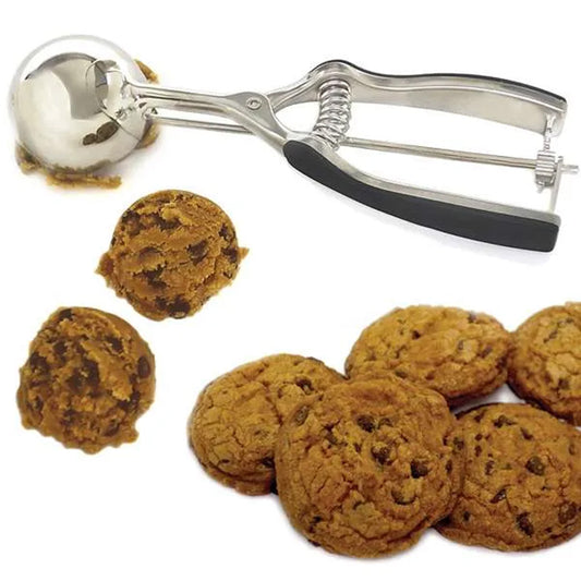Three-tablespoon stainless steel cookie scoop shown with rounded chocolate chip cookie dough portions and baked cookies.
