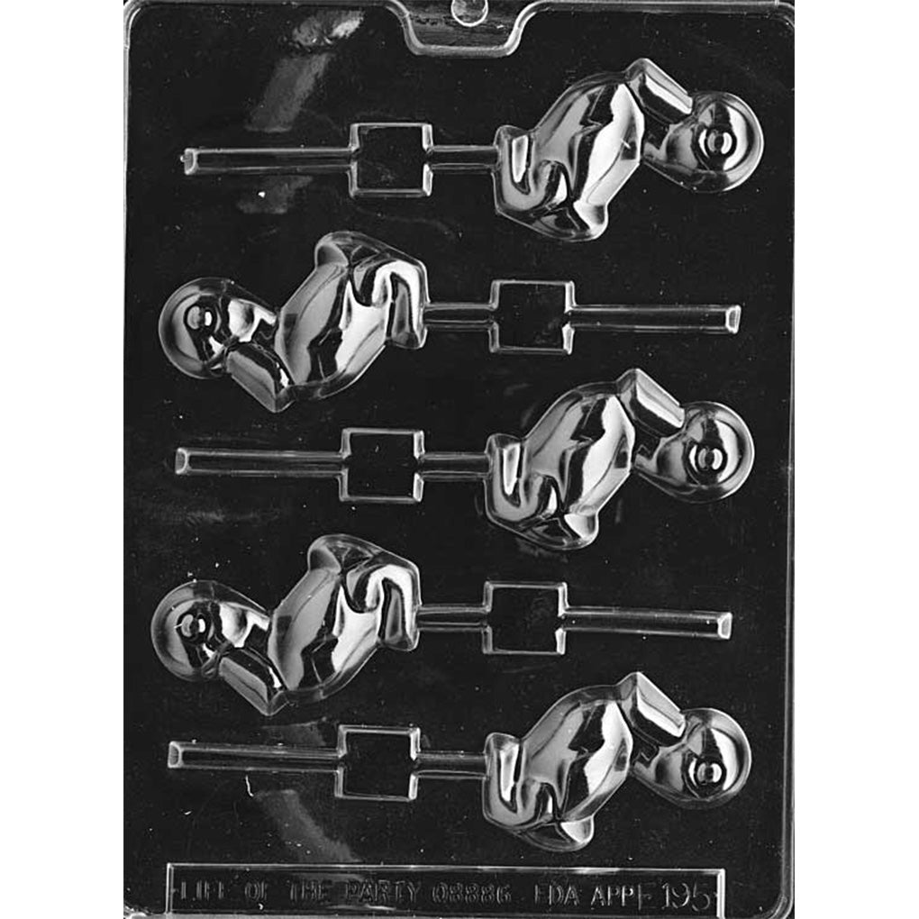 Clear plastic chocolate lollipop mold with six duckling-shaped cavities showing a sitting duck with a raised eye and curved bill, each cavity aligned with a lollipop stick channel on a dark background.
