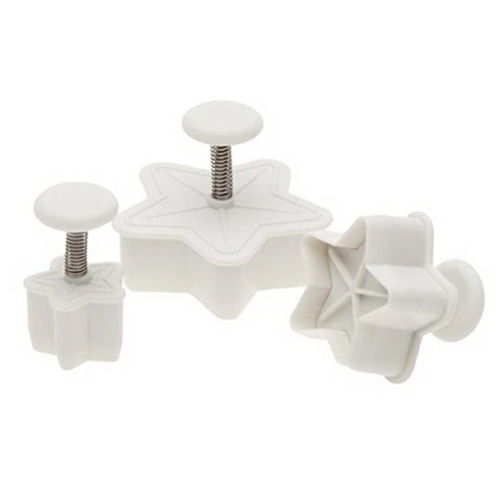 Set of three white star-shaped pastry plunger cutters in 3/4, 1 1/4, and 1 3/4-inch sizes with spring-loaded handles