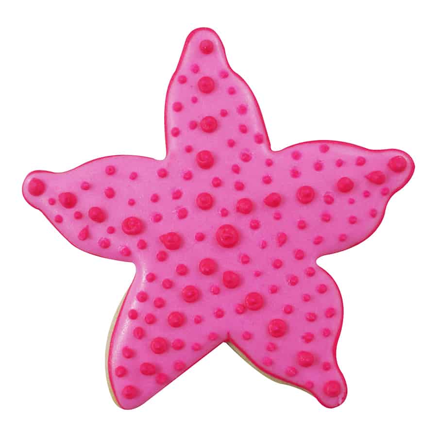 Decorated starfish-shaped sugar cookie with bright pink royal icing and raised red icing dots for a realistic textured effect.