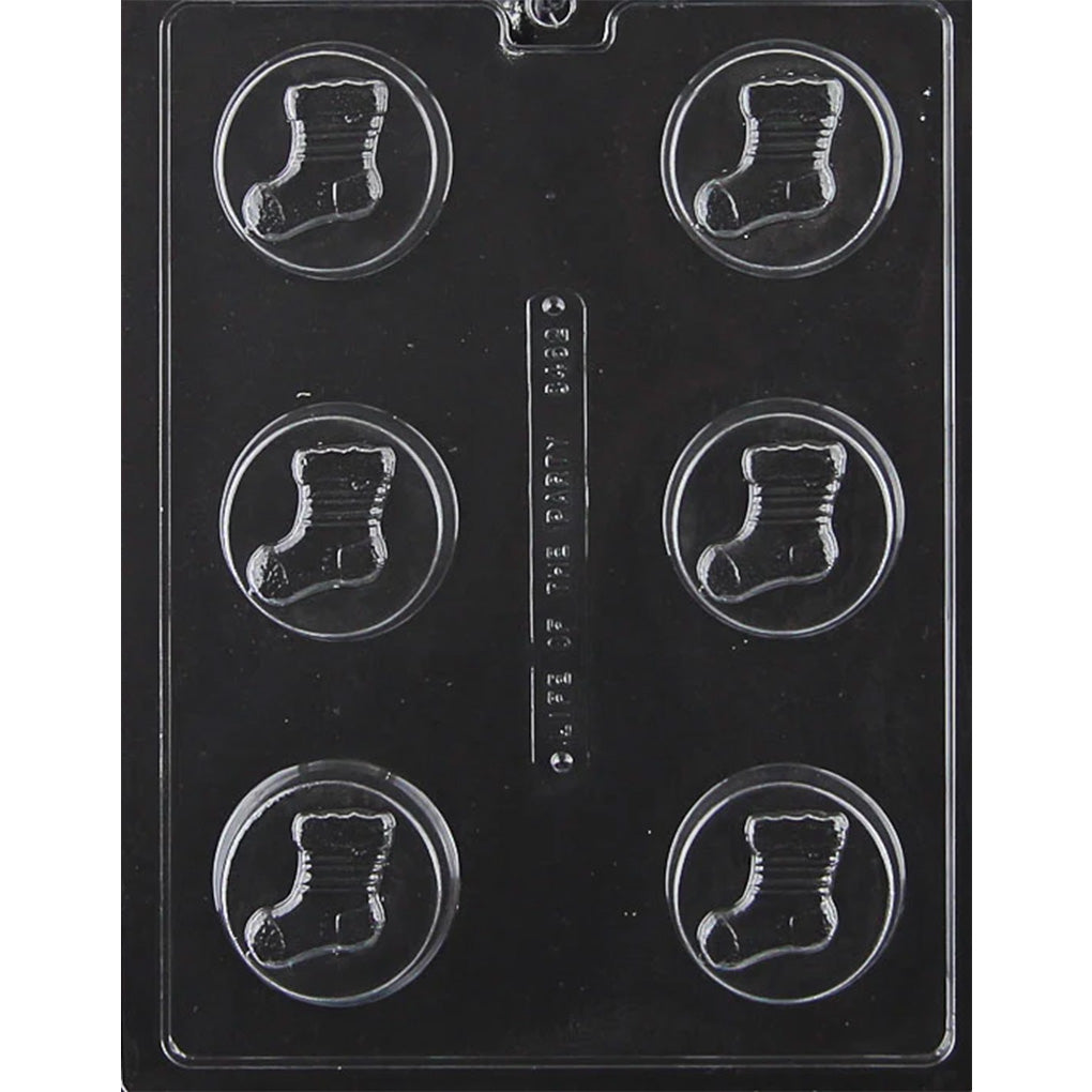 Clear plastic chocolate mold with six round cavities, each featuring a raised Christmas stocking design for chocolate covered sandwich cookies