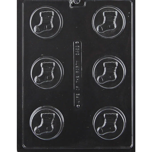 Clear plastic chocolate mold with six round cavities, each featuring a raised Christmas stocking design for chocolate covered sandwich cookies