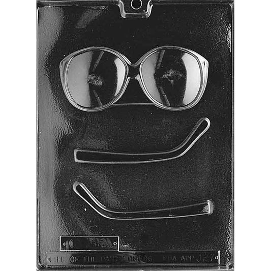 Clear chocolate mold with three cavities for making sunglasses, including one large front frame with two rounded lenses and two separate curved arms.