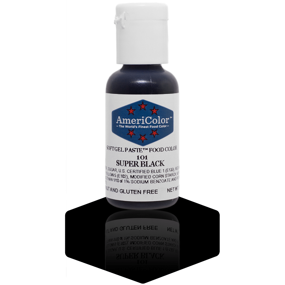 A small bottle of AmeriColor Super Black soft gel paste food coloring, featuring a white cap and blue label with red stars, standing on a glossy black surface with its reflection visible.