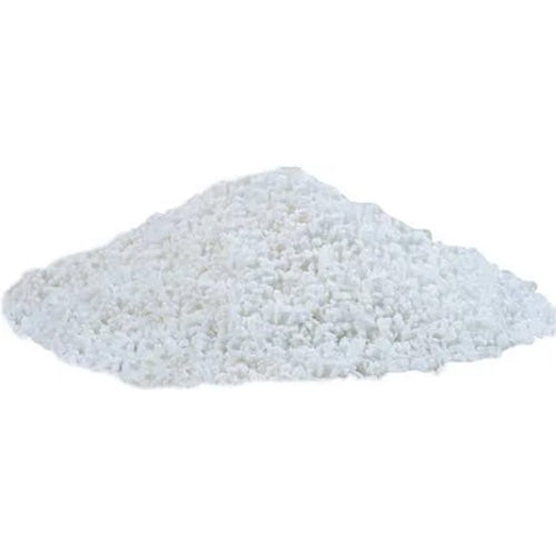 Pile of Swedish pearl sugar with small white, crunchy sugar pearls clustered together on a white background.