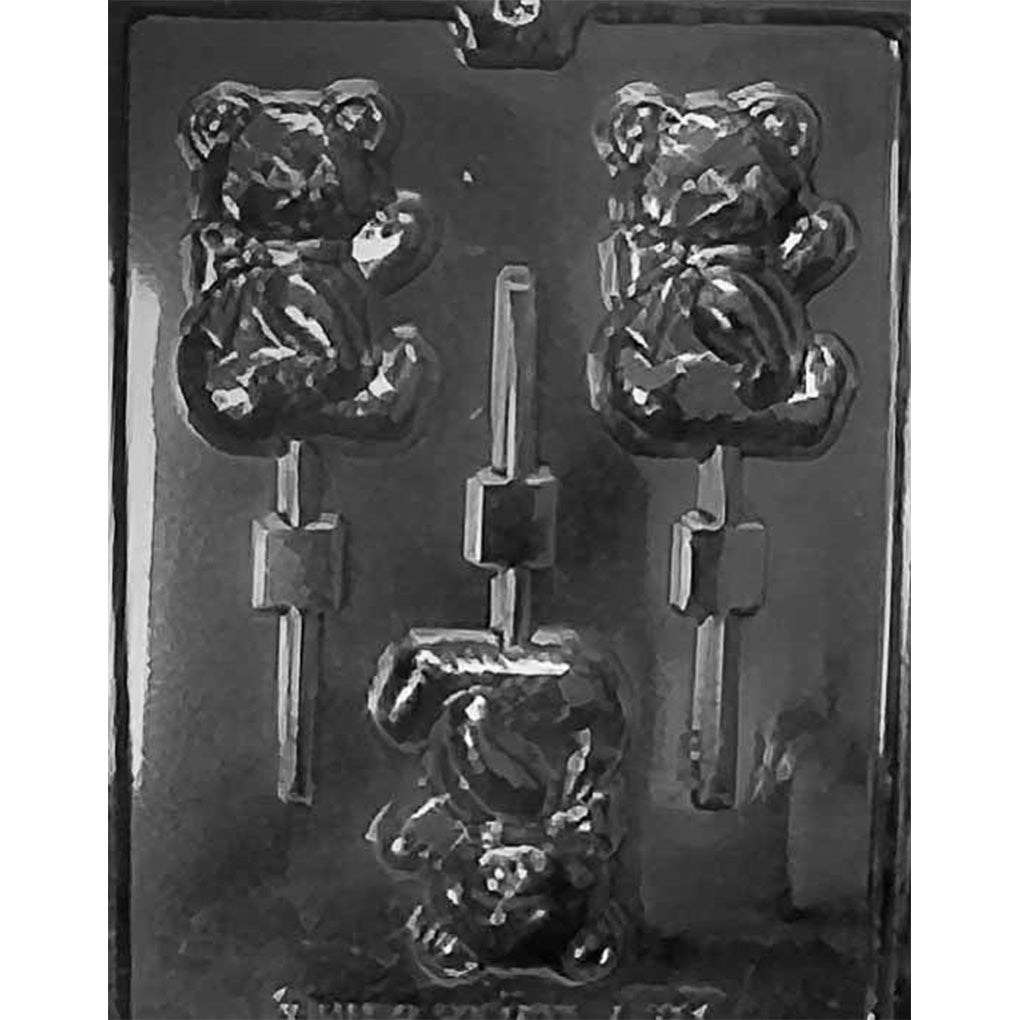 Chocolate lollipop mold with three seated teddy bear cavities arranged in alternating directions with molded stick channels.