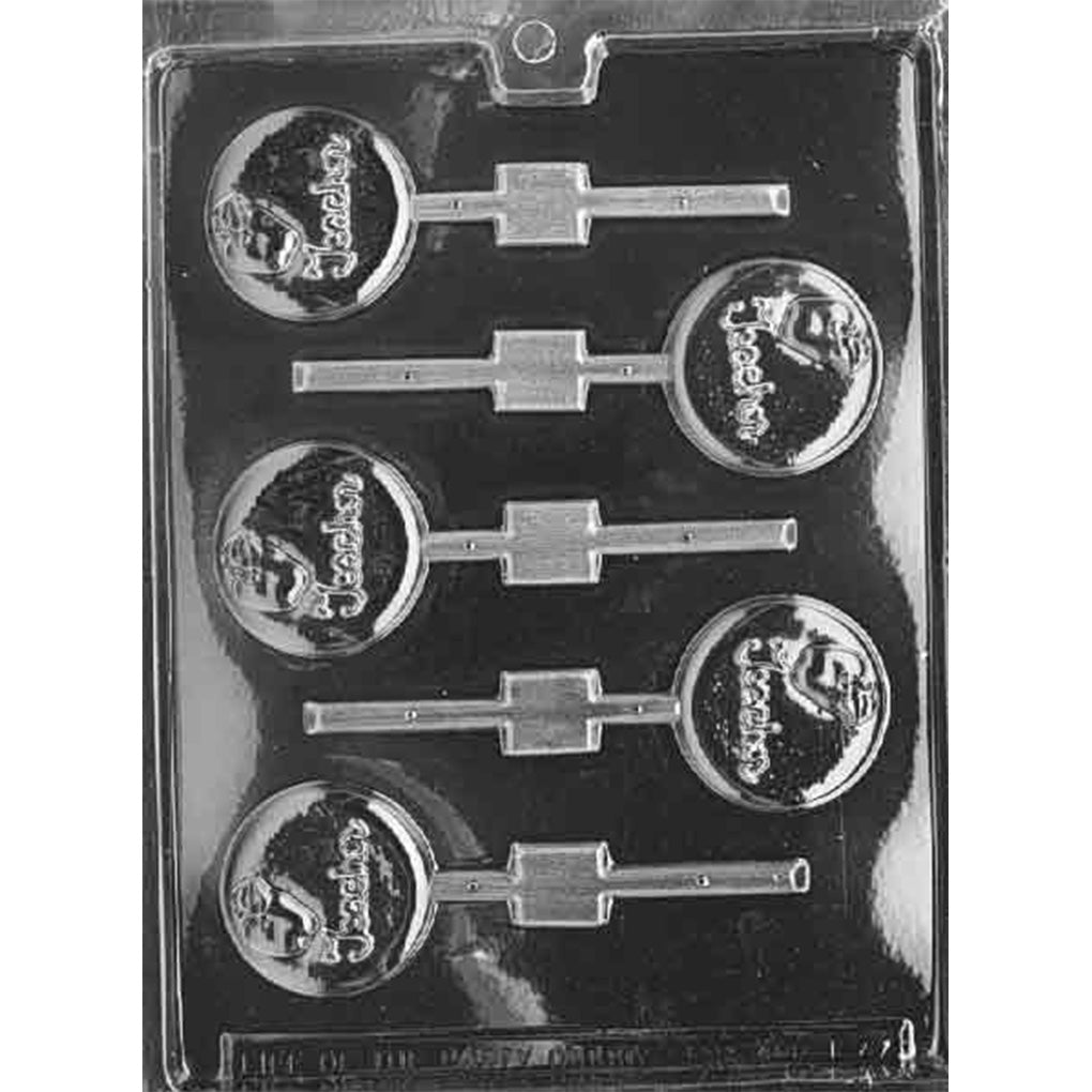 Clear Teacher Chocolate Lollipop Mold with six round cavities embossed with the word Teacher and an apple, each with a stick channel, shown on a black background.