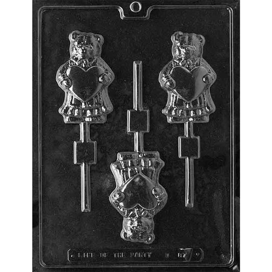 Clear plastic chocolate lollipop mold with three cavities shaped like a teddy bear holding a heart.