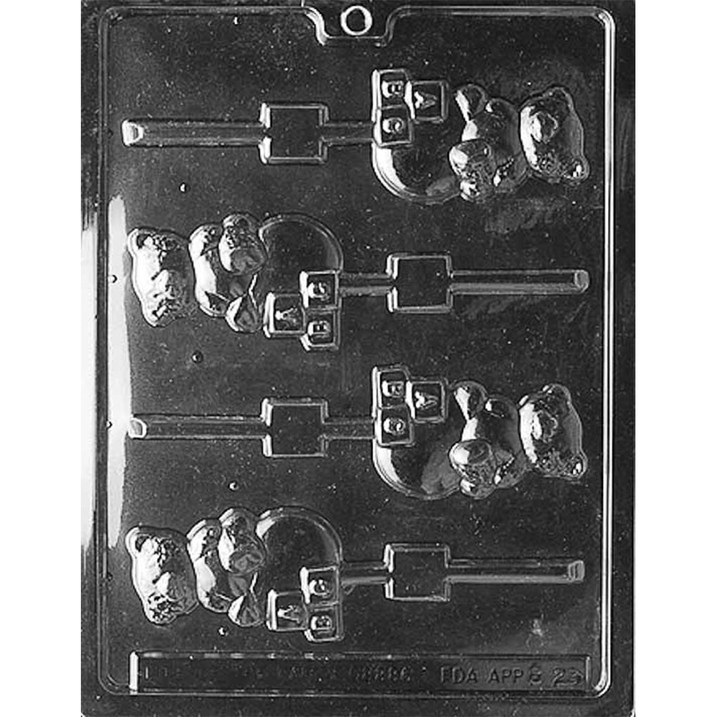 Clear plastic chocolate lollipop mold with teddy bear shapes featuring toy blocks and a round ball, each cavity connected to a stick channel.