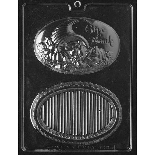 Chocolate pour box mold with two oval cavities: a cornucopia lid reading Give Thanks and a ribbed base with a scalloped border