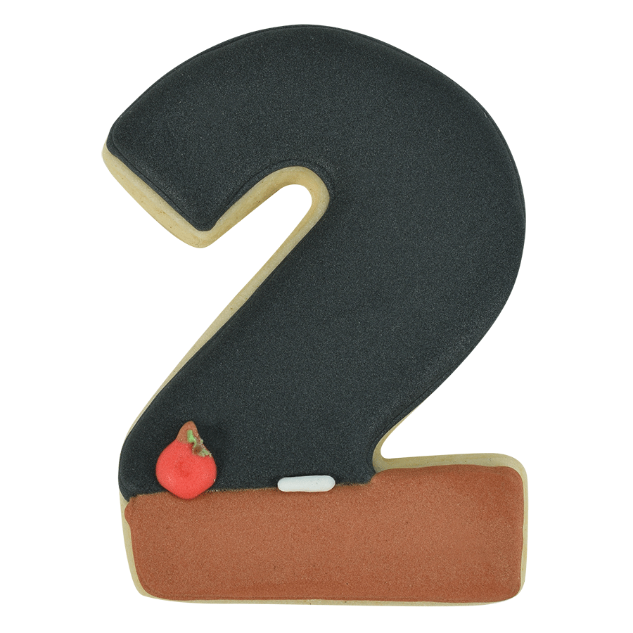 Number 2-shaped cookie decorated with black and brown icing, featuring a chalkboard-inspired design with a red apple.