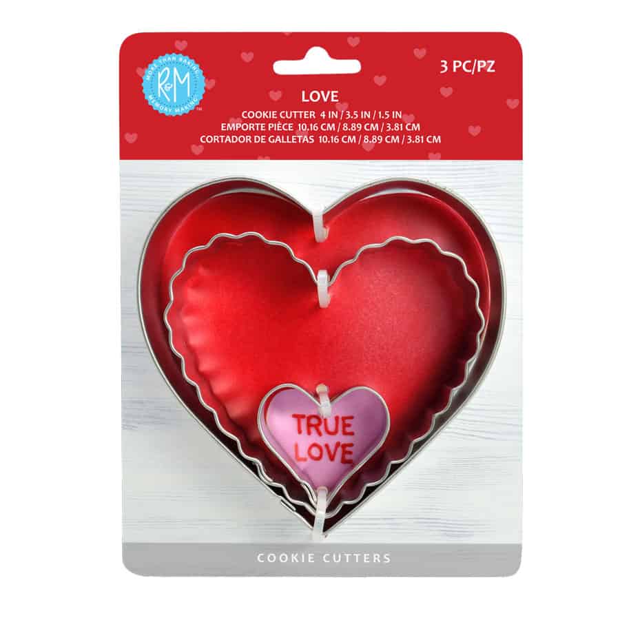 Love-themed heart cookie cutter set in packaging, featuring three nested metal cutters with a red background.