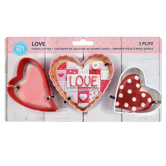 Love Heart 3 Piece Cookie Cutter Set in packaging, featuring three heart-shaped cutters with soft grips in red and white.