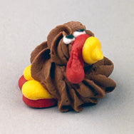 Mini turkey royal icing decorations in a 4-pack, each 3/4 inch tall with colorful feathers and cute Thanksgiving-themed design
