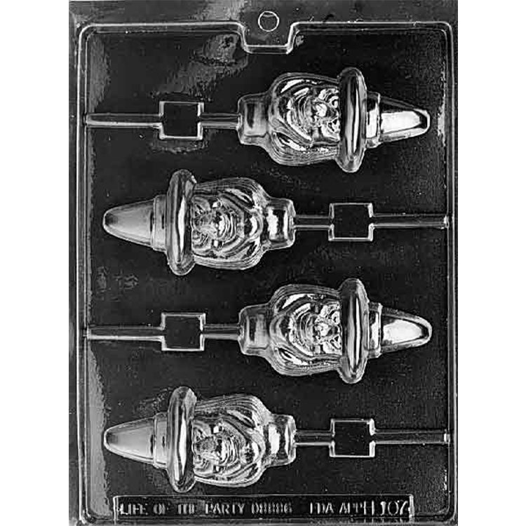 Clear plastic chocolate lollipop mold photographed on a black background with four witch-shaped lollipop cavities, each showing a smiling witch face with a pointed hat and stick channel.