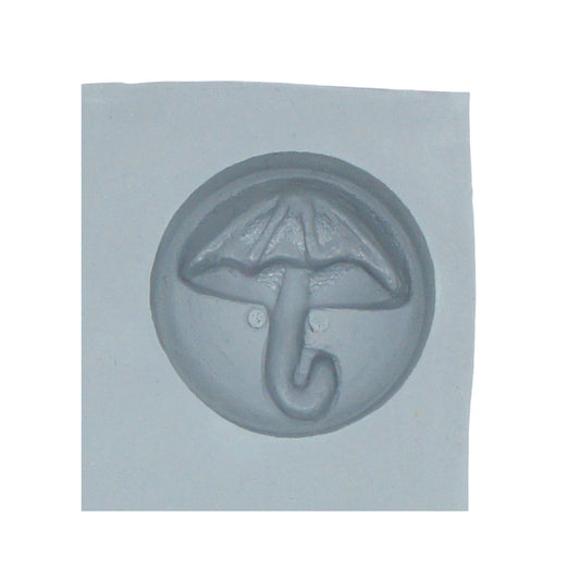 Close-up of umbrella rubber mint mold cavity featuring rounded shape and embossed umbrella design for spring or baby shower treats