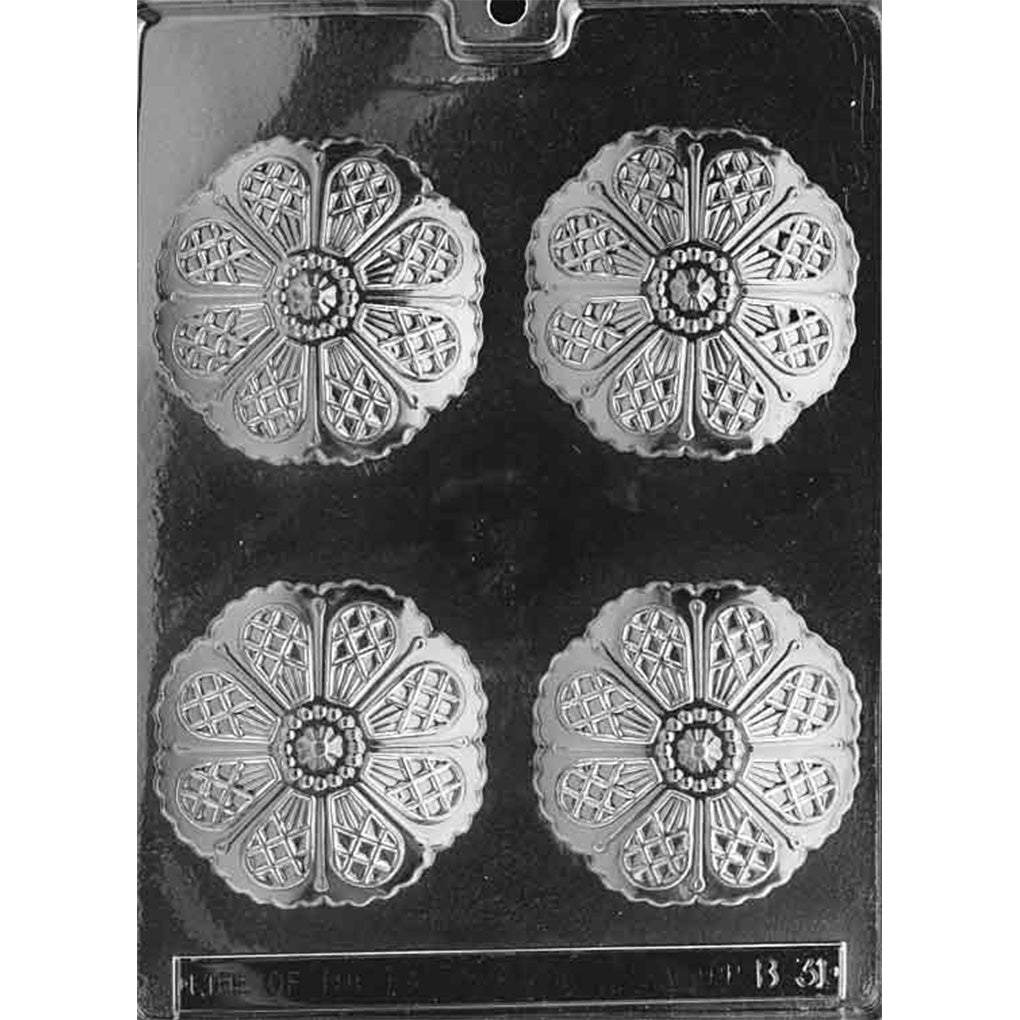 Clear plastic chocolate mold photographed against a black background, featuring four round umbrella canopy disc cavities with detailed ribbed segments and a decorative center.