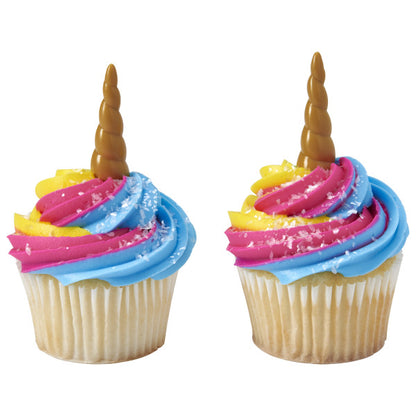 Cupcakes with bright pink, yellow, and blue frosting swirls topped with unicorn horn picks.