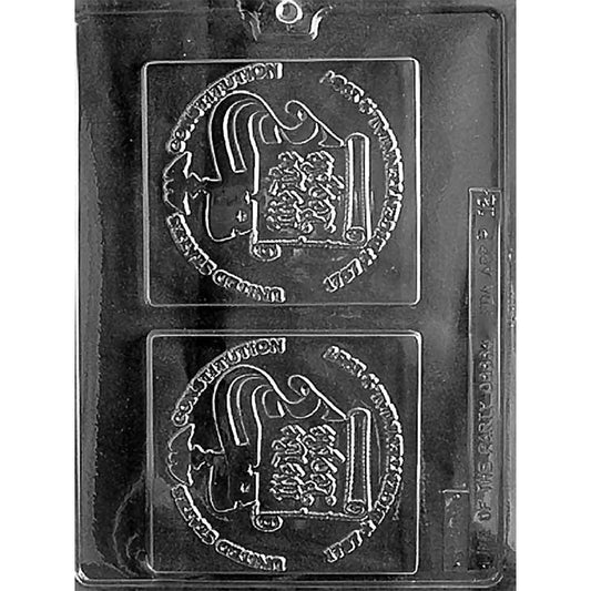 Clear U.S. Constitution Chocolate Mold photographed against a black background with two large square plaque cavities featuring a Constitution scroll, patriotic lettering, and raised emblem details.