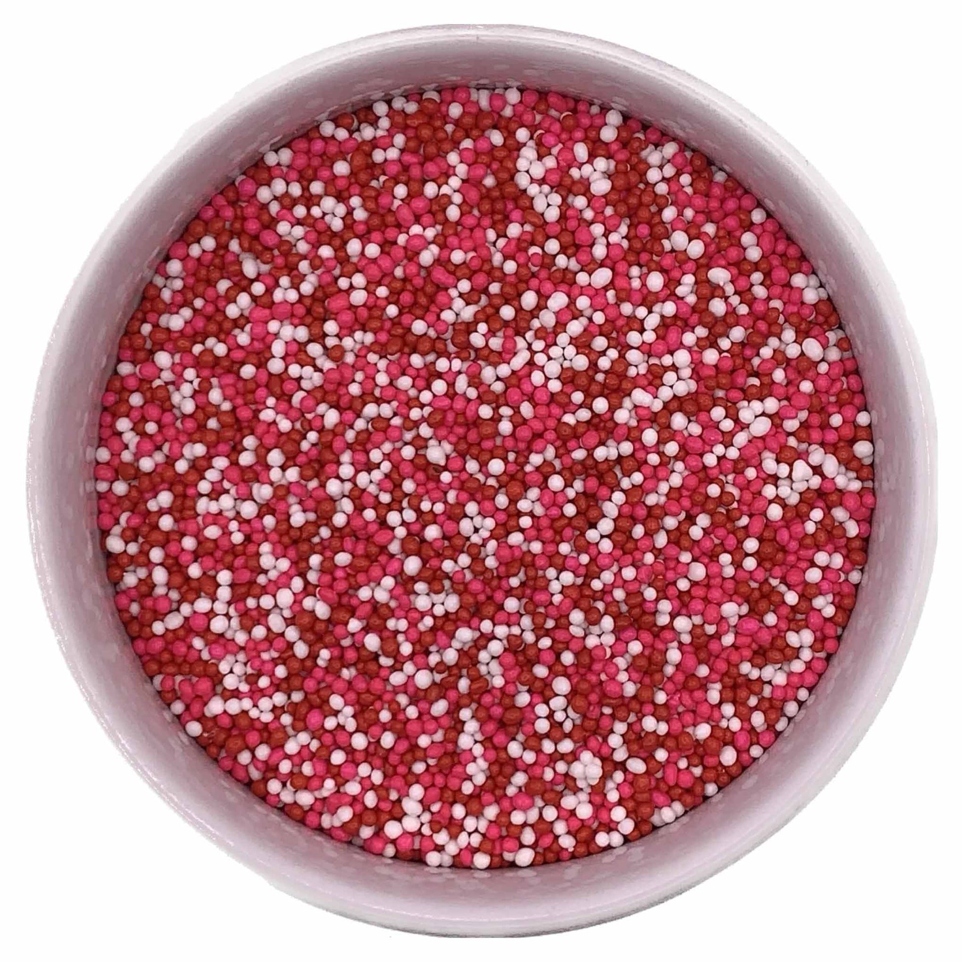 Top view of Valentine non-pareils mix featuring red, pink, and white mini sprinkles in a round container.