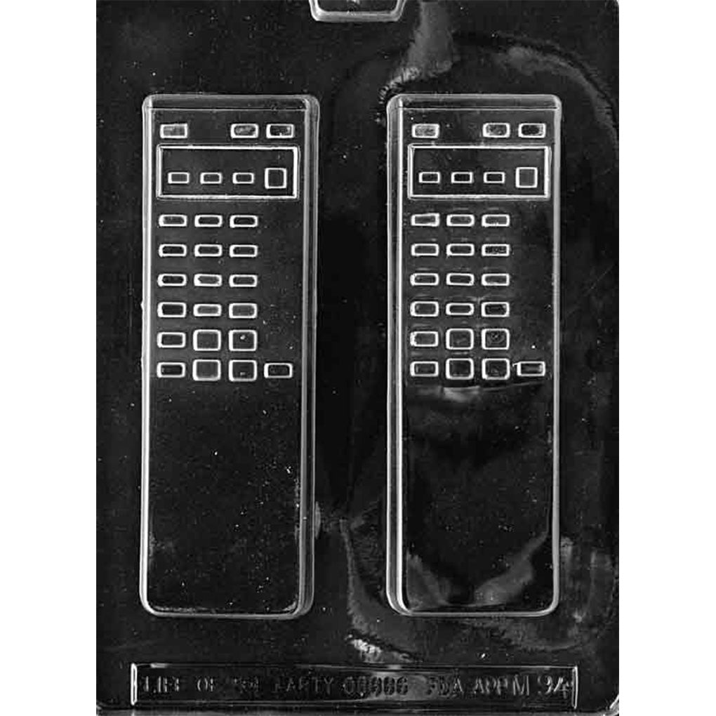 Clear plastic vintage remote control chocolate mold with two long rectangular remote cavities featuring raised button grids and a display panel, on a dark background.