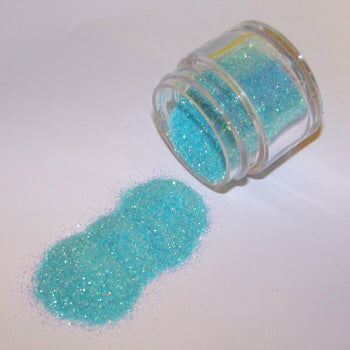 Light aqua Galaxy Glitter Dust spilled from a jar, sparkling with frosty shimmer and pastel iridescent highlights.