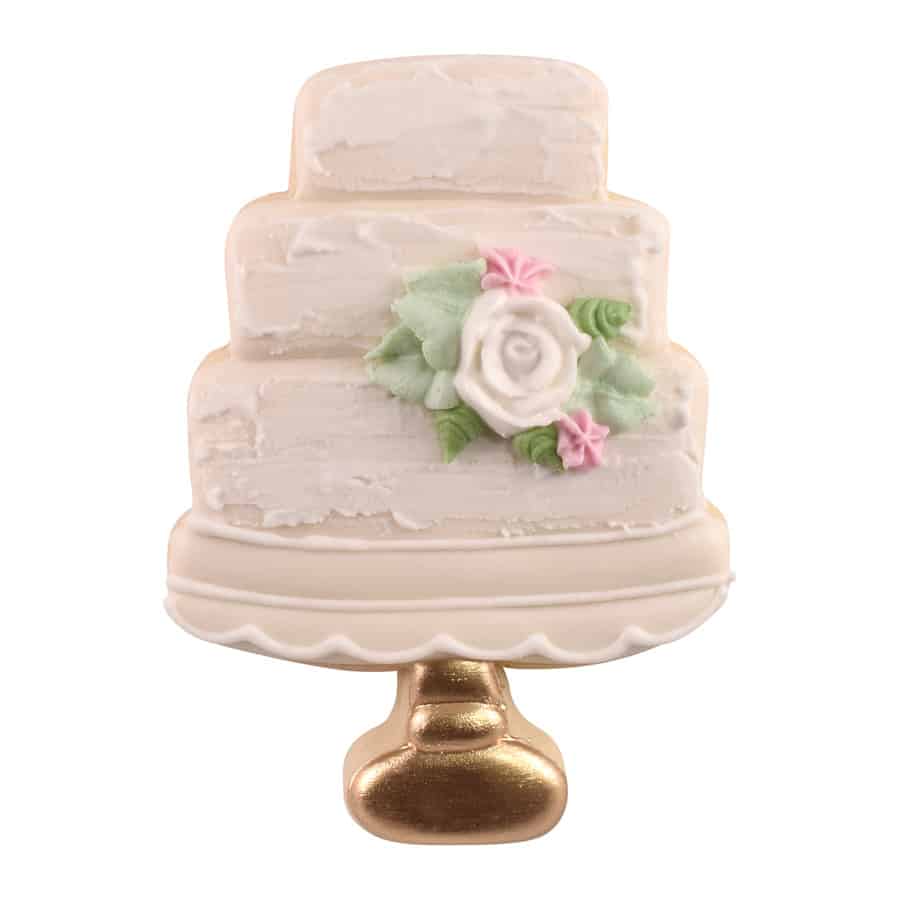 A decorated wedding cake cookie with white icing, textured tiers, floral details, and a gold cake stand.