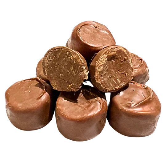 Stack of round whipped chocolate candy centers, some cut to show fluffy interior texture.