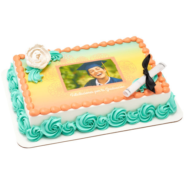 Rectangular graduation cake with printed photo topper, teal icing accents, and white briar rose decoration