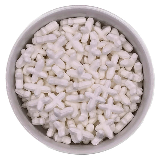 Close-up of thick white cross-shaped sprinkles, approximately 5/8 inch long, displayed in a round white bowl.