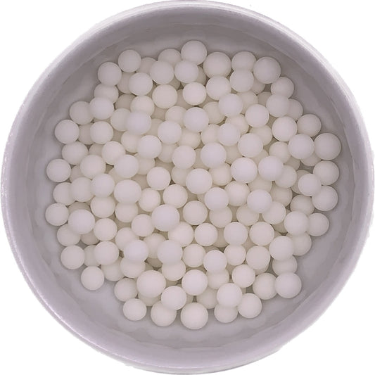 Bowl of white/ivory non-pearlized 6mm sugar pearls with a matte finish, ideal for decorating cakes, cupcakes, and cookies.