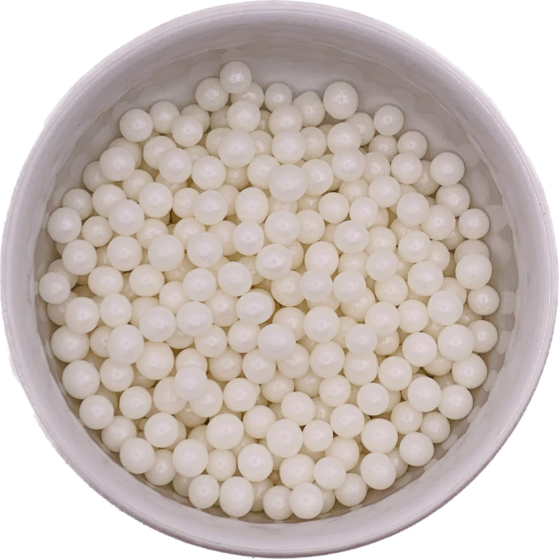 Glossy 6mm white pearl dragees in a bowl, ideal for elegant cake and cupcake decorating.
