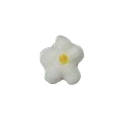 Small white royal icing drop flower with five-petals and a yellow center, isolated on a light background.
