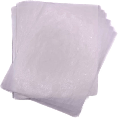 Overlapping stack of lightly translucent white 4" x 5" wax caramel wrappers shown flat against a white background.