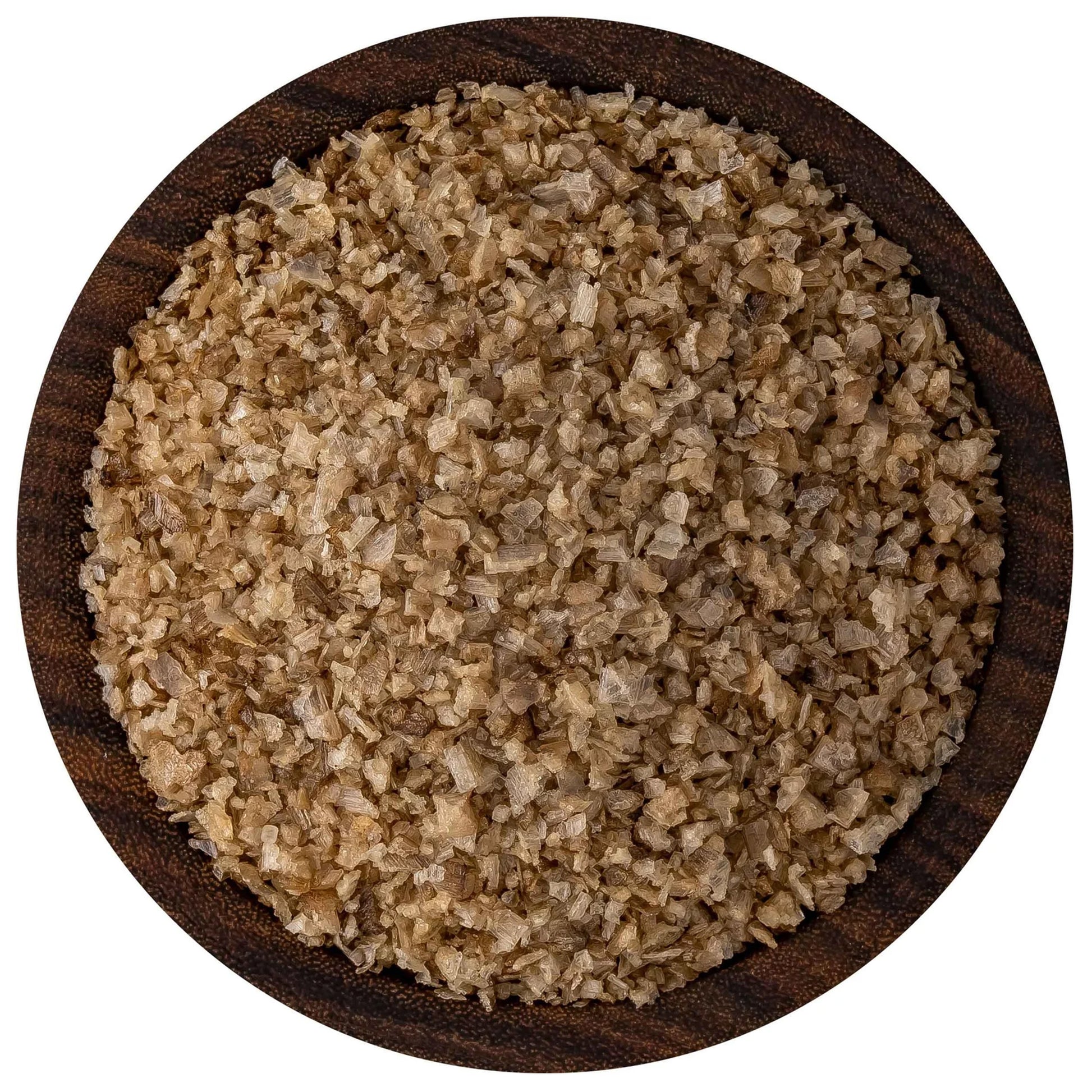 Overhead view of applewood smoked sea salt in a round dark wooden bowl, showing tan-brown flake crystals with uneven, rustic texture.