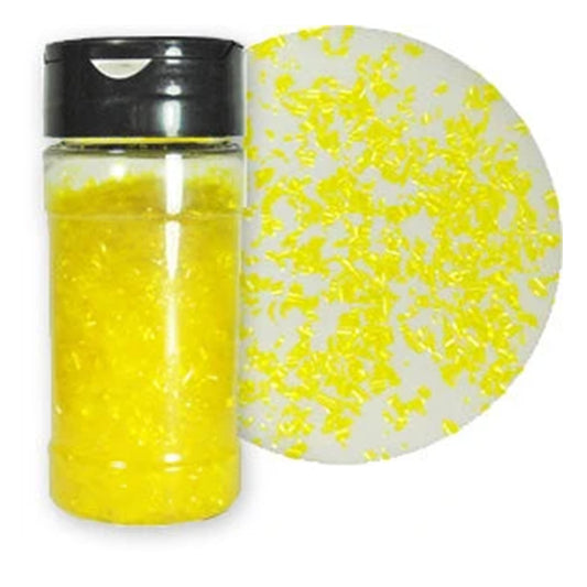 Yellow Edible Glitter Flakes in a clear container with a black lid beside a close-up of the thin, bright yellow flakes