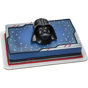 Star Wars-themed rectangular cake featuring a Darth Vader topper on a space-inspired design.
