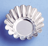 Close-up of a fluted 3 1/2" brioche tart mold with scalloped sides on a light blue background.