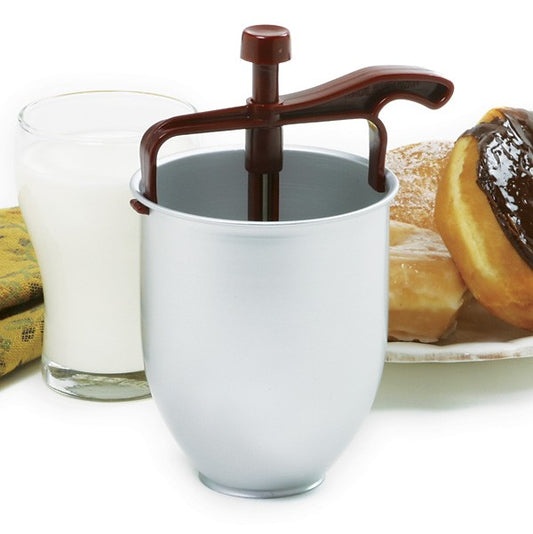 Donut batter dispenser beside a glass of milk and fresh donuts, ready for baking