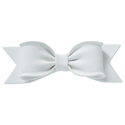 Front view of a large white gum paste bow with realistic folds and ribbon tails, designed for cake decorating.
