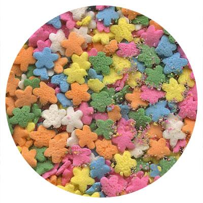 Daisy-shaped pastel sprinkles in pink, yellow, blue, green, orange, and white colors.